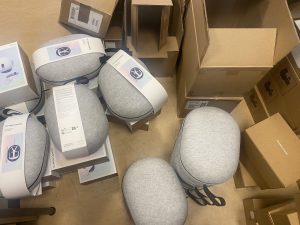 Cases for VR headsets beside the boxes they were delivered in on an office floor.