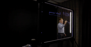 Man writing on a lightboard